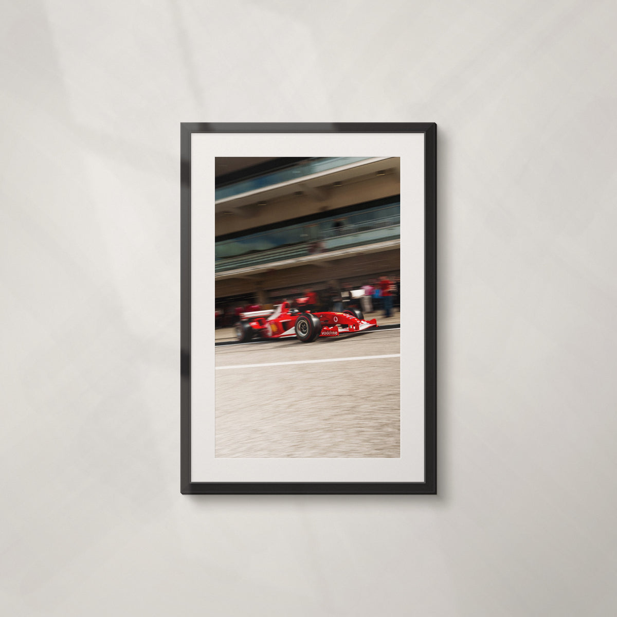 Analog Era: framed print of a red Formula One car in the pit lane