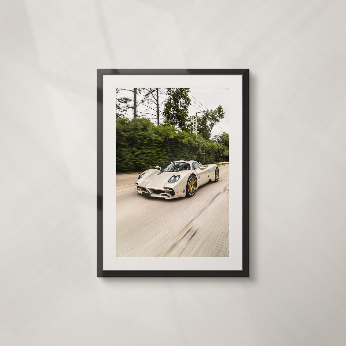 Green Flag: framed print of a Pagani Utopia at speed past green hedges